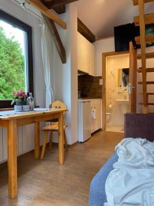 a room with a desk and a kitchen with a window at Cerla Korbielów in Korbielów