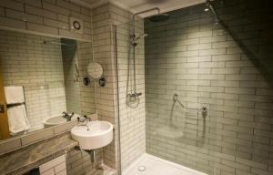 a bathroom with a sink and a shower at The New Hobbit Hotel Rooms in Halifax
