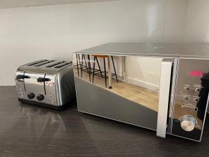 a kitchen with a stove and a toaster oven at Entire Modern Home Middlesbrough in Middlesbrough
