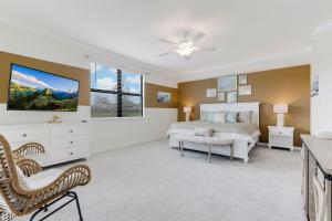 a bedroom with a bed and a tv on the wall at STUNNING New Construction Condo close to everything! - Condo Coastal Soul - Roelens Vacations in Fort Myers Villas
