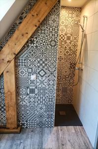 a bathroom with a shower with a tile wall at La Villa Perigourdine in Sarlat-la-Canéda +54 photos