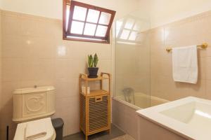 a bathroom with a toilet and a sink and a mirror at Pilar House in Funchal +16 photos