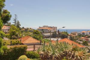 a view of a city with houses and the ocean at Pilar House in Funchal