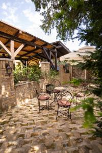 a patio with a table and chairs on a stone patio at Garden House in Apatin