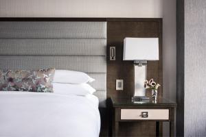 a hotel room with a bed and a table with a lamp at The Ritz-Carlton Atlanta in Atlanta