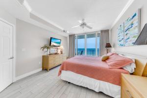 a bedroom with a bed and a view of the ocean at San Carlos 604 in Gulf Shores