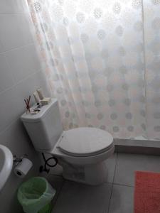 a bathroom with a toilet and a shower curtain at Tropical Oasis, Verano Inolvidable! 