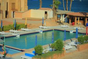 a swimming pool in a resort near the ocean at Mashrabiya Hotel in Hurghada