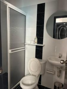 a bathroom with a toilet and a sink and a shower at HospedajeLR in Barrancabermeja