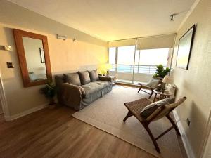 sala de estar con sofá y ventana grande en Del Mar, en Viña del Mar