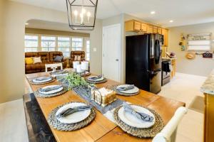 a kitchen and dining room with a table with plates on it at Epic Family Getaway with Pool, Game Room and Fire Pit! in East Wenatchee