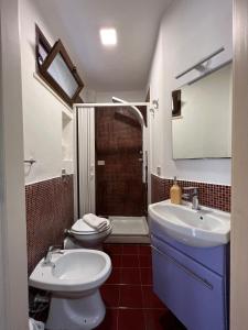 a bathroom with a toilet and a sink and a shower at Il Vico in Trapani +20 photos