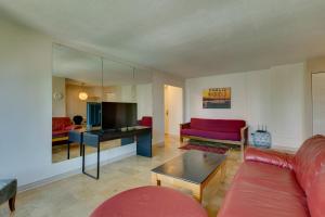 a living room with a red couch and a tv at Downtown Seattle Condo with Rooftop Deck and Views! in Seattle