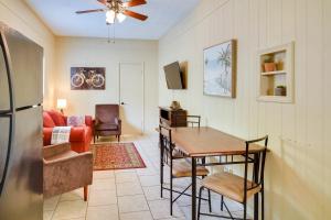a living room with a table and a couch at Lake Charles Vacation Rental with Private Patio! in Lake Charles