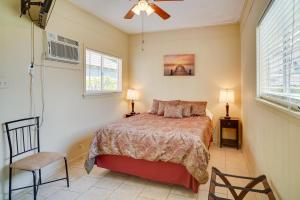 a bedroom with a bed and a ceiling fan at Lake Charles Vacation Rental with Private Patio! in Lake Charles