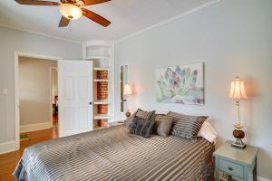 a bedroom with a bed and a ceiling fan at Lake Charles Vacation Rental - Walk to the Lake! in Lake Charles