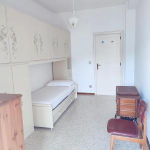 a bedroom with a bed and a chair and a table at Casa Tanja in Pescara