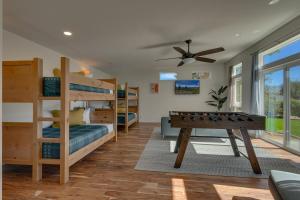 a bedroom with bunk beds and a pool table at @ Marbella Lane - Eccentric 4BR Modern Ranch Home in Reno