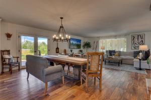 a living room with a wooden table and chairs at @ Marbella Lane - Eccentric 4BR Modern Ranch Home in Reno