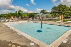a swimming pool with a fountain in a park at Family-Friendly DuBois Cabin with Community Pool! in DuBois