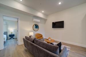 a living room with a couch and a tv at DreamStay on Clay in Muskegon