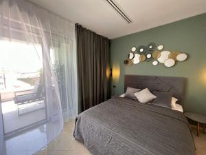 a bedroom with a large bed and a balcony at LEO Apartment FREE PARKING - President Palace in Bratislava