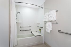 a bathroom with white towels and a shower at Holiday Inn Express Crystal River, an IHG Hotel in Crystal River