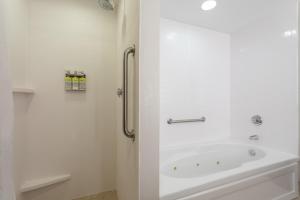 a white bathroom with a tub and a shower at Holiday Inn Express Crystal River, an IHG Hotel in Crystal River