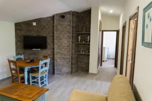 a living room with a couch and a table at Casa rural Mirador del Río Tus, en Yeste in Yeste