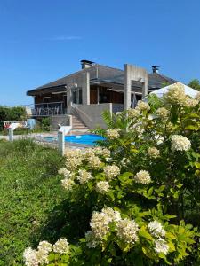 a house with a swimming pool and some flowers at Gemütliches Haus in Seewalchen am Attersee in Seewalchen