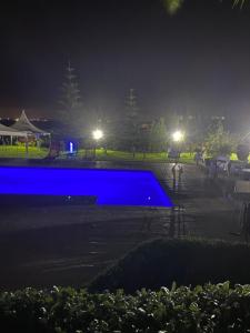 a swimming pool in a park at night at Gîte Jnane fès in El Jadida