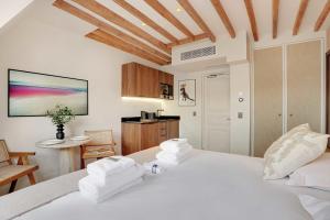 a bedroom with a white bed with towels on it at Amazing studio - Louvre Place Vendome in Paris