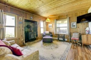 a living room with a couch and a fireplace at Historic Alpine Cabin with Scenic Mount Sopris View in Glenwood Springs