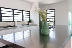 a kitchen with a sink and a vase on a table at Charming Villa With Breathtaking View Over The Spanish Water in Willemstad