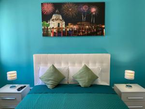 a bedroom with a bed with fireworks in the background at venice popular residence in Mestre