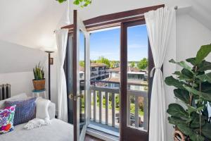 a room with a balcony with a sliding glass door at Rare find in Kitsilano! in Vancouver