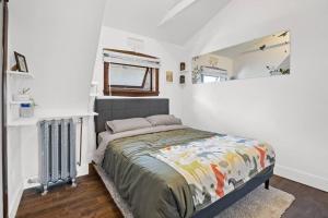ein Schlafzimmer mit einem Bett in einem weißen Zimmer in der Unterkunft Rare find in Kitsilano! in Vancouver