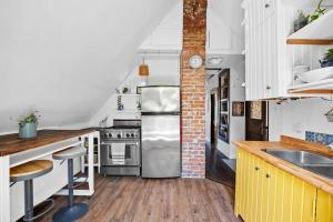 a kitchen with a stainless steel refrigerator in it at Rare find in Kitsilano! in Vancouver