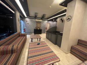 a living room with two chairs and a table at Sandra Hotel in Amman