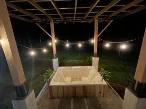 a bath tub in a backyard at night at River Paradise Villa in Fortuna