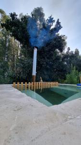 a fountain with blue smoke coming out of it at RAMAL LODGE CONSTITUCION in Constitución