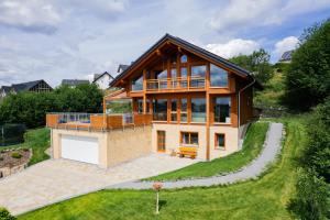 a house on a hill with a yard at Chalet Winterberg in Winterberg