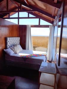 Ένα ή περισσότερα κρεβάτια σε δωμάτιο στο Titicaca Magical Lodge Peru
