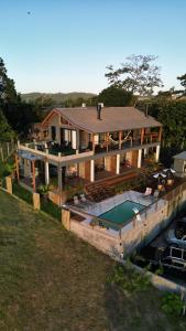 an aerial view of a house with a swimming pool at VENTO TERRAL SURF STUDIOS in Imbituba