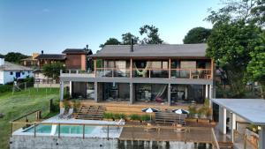 a large house with a pool in front of it at VENTO TERRAL SURF STUDIOS in Imbituba