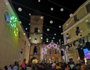 a crowd of people in a building with a clock tower at Casa alla Costa in Mormanno