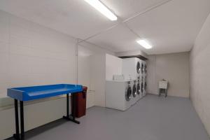 a laundry room with a blue table and a washing machine at Red Roof Inn Vero Beach - I-95 in Vero Beach