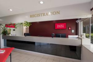 a reception desk with a sign that reads restoration at Red Roof Inn Vero Beach - I-95 in Vero Beach