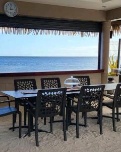 a table and chairs with a view of the ocean at Le Village de Vairao in Vairao