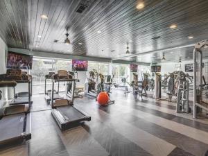 a gym with several tread machines and a ball in it at LUX 2 BD BOHO in heart of SLC in Salt Lake City